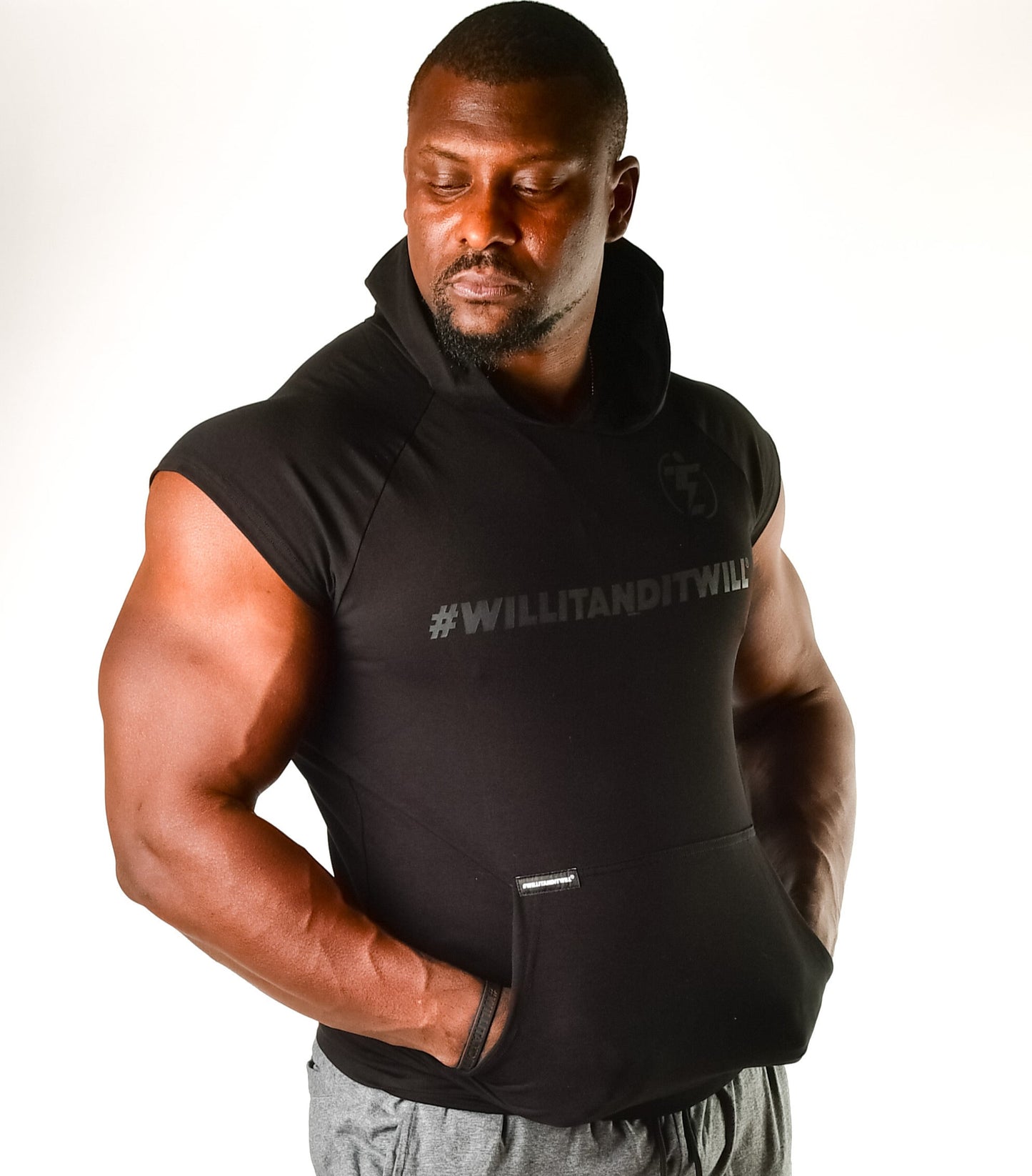 Man in black #WILLITANDITWILL sleeveless hoodie with front pocket.