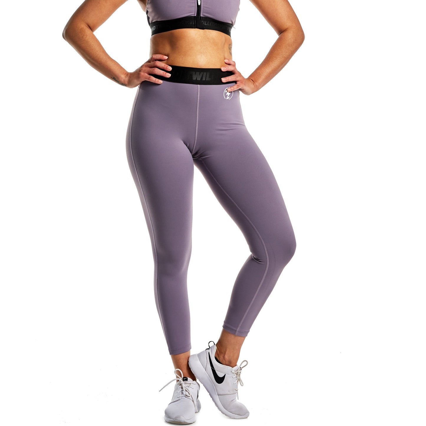 Model wearing lilac activewear set with leggings and sports bra. Comfortable athletic apparel.