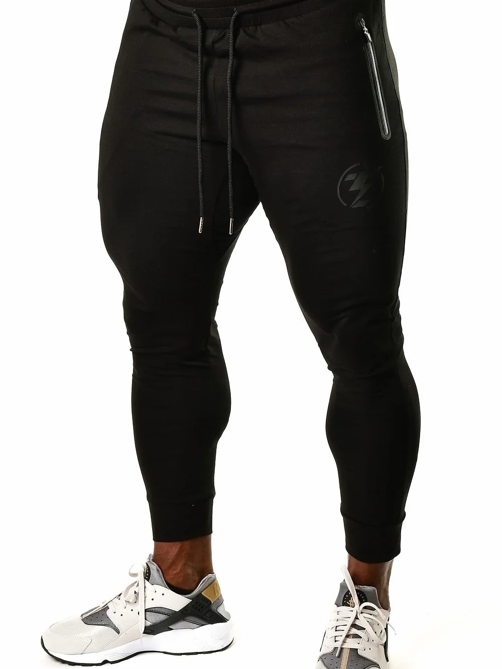 Black athletic joggers with drawstring and zipper pocket detail.