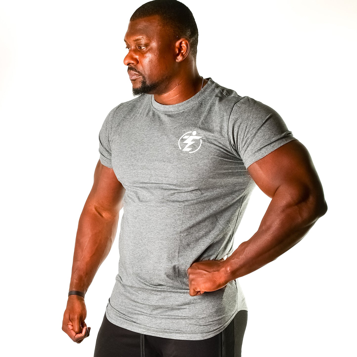 Man in gray athletic t-shirt and black shorts. Gym wear for fitness and training with logo on the chest.