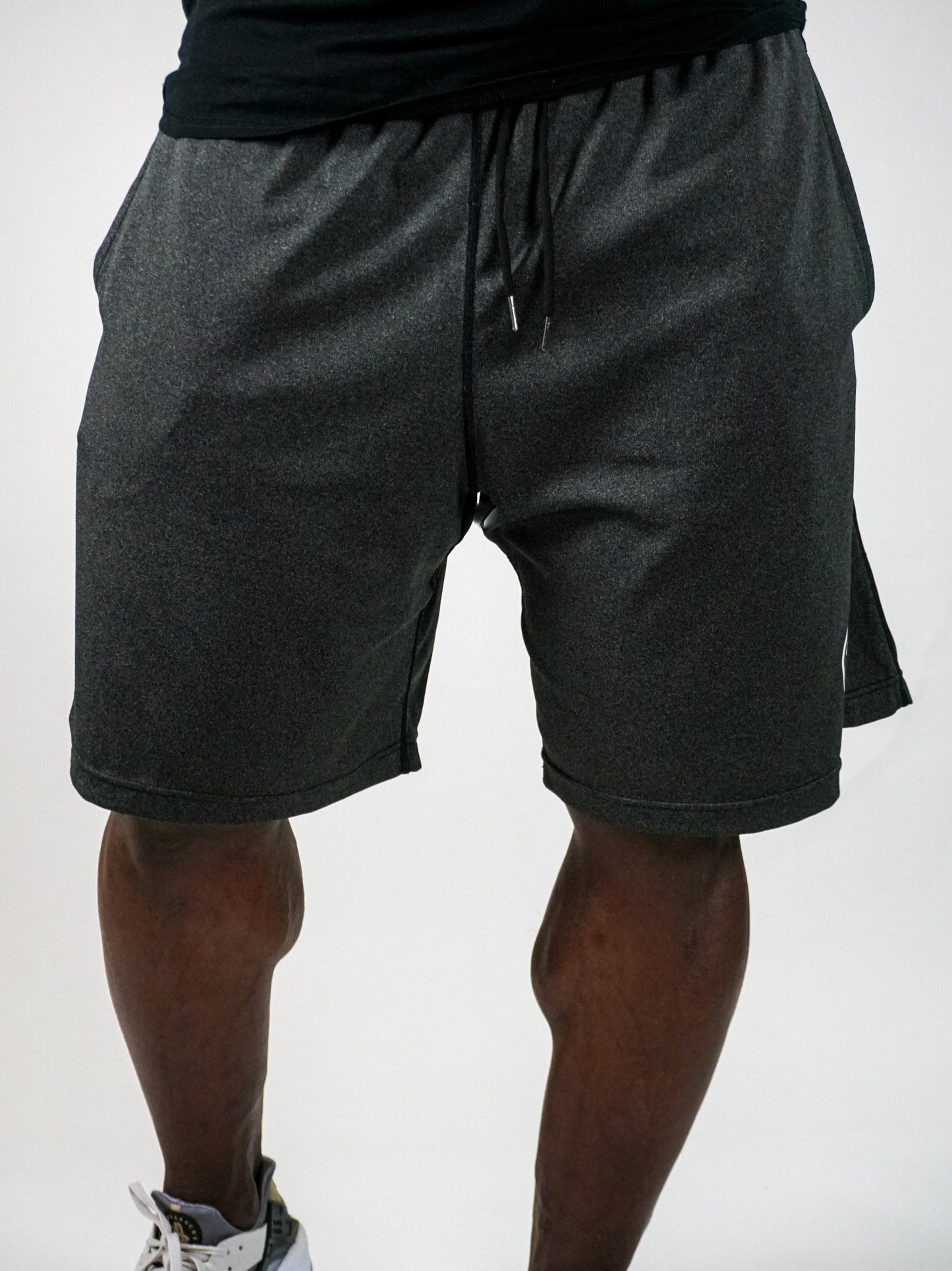 Gray athletic shorts with drawstring on model.