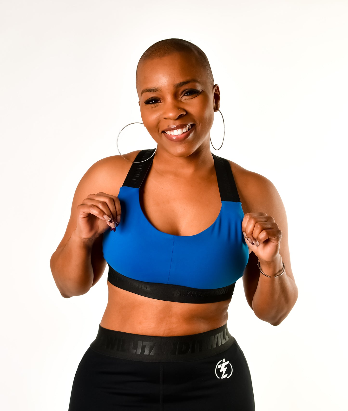 Woman in blue sports bra and black leggings. Athletic apparel.
