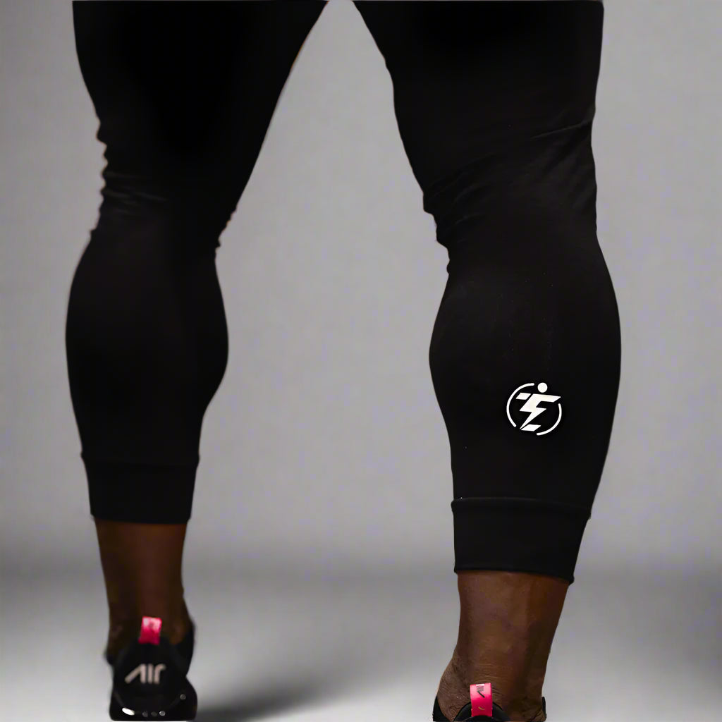 Close-up of black athletic leggings with white logo detail.